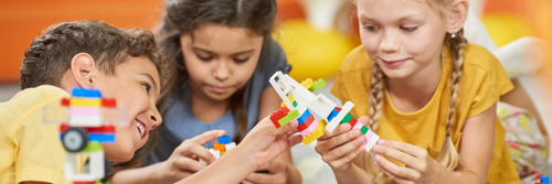 children building with LEGO blocks